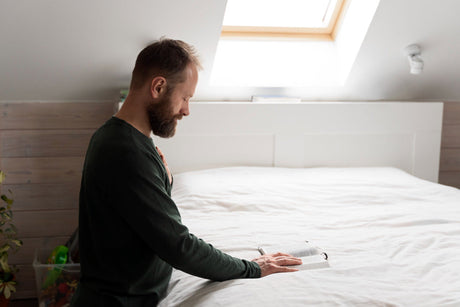 "King size mattress in a showroom with info tags highlighting key buyer concerns like firmness, size, support, and materials."