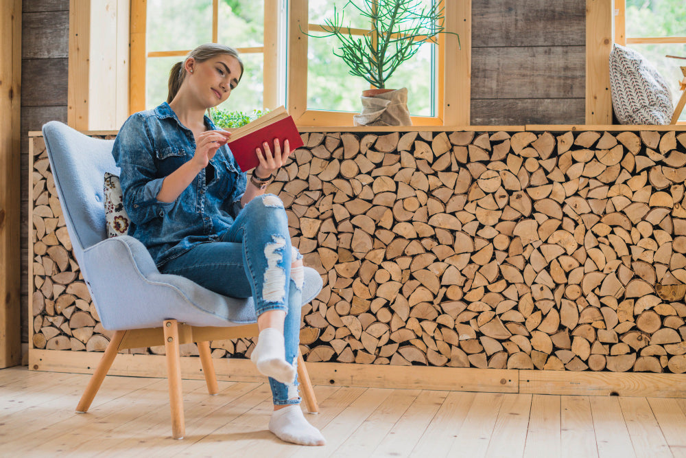 "Cozy reading nook setup with a plush armchair, floor lamp, and bookshelves, highlighting comfort and relaxation."