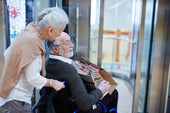 "Senior comfortably using a power lift recliner, illustrating ease of standing and sitting with supportive, motorized assistance."