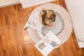  "Cozy room featuring a round rug beneath a coffee table, adding warmth and soft curves to balance sharp lines in the décor."