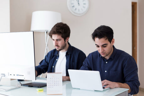 "All-in-one and traditional desktop computers side by side, comparing space-saving design versus expandability."