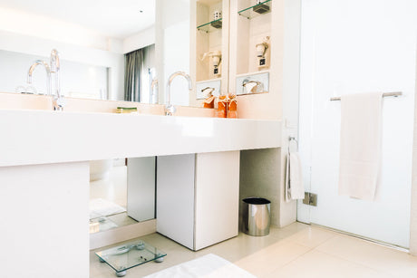 "Side-by-side bathroom setup featuring a wall-hung vanity and a floor-standing vanity, highlighting differences in style, space usage, and installation type."