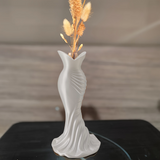 This elegant dress vase combines high-fashion elegance with minimalist home décor. Whether you insert real flowers into the glass tube or display artificial flowers without the tube, it is exceptionally beautiful.