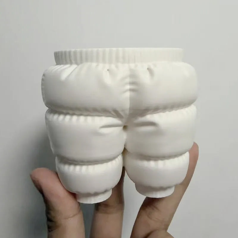 A unique 3D printed down-filled pants pen holder desktop organizer, white.