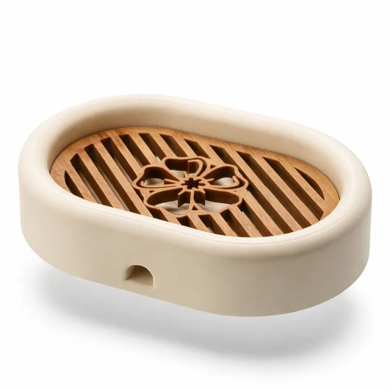 3D-printed oval soap dish with drain rack, white and wood-look.