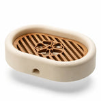 3D-printed oval soap dish with drain rack, white and wood-look.