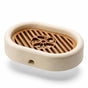 3D-printed oval soap dish with drain rack, white and wood-look.