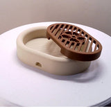 3D-printed oval soap dish with drain rack, white and wood-look. - Front View