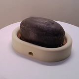 3D-printed oval soap dish with drain rack, white and wood-look. - Side View