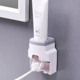 Automatic Toothpaste Dispenser Squeezer with Toothbrush Holder Wall Mounted for Bathroom Adults KidsGrey - Close-Up Angle