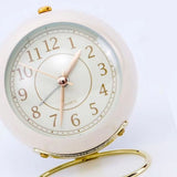 Small Round Clock Circular Base Mute Corrosion Resistance Quartz Bedside Alarm Clock with Night Light for Bedroom School Creamy White, Golden Cover - Top-Down View