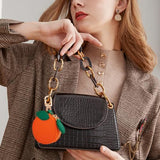 Mini Fruit Keychain Pouch Perfect for Backpacks, Purses, and Daily Carry Essentials (Orange) - 45-Degree Angle
