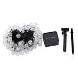 NOVEDEN 100-Bulb Warm White Solar String Lights with 8 Lighting Modes - Low Angle