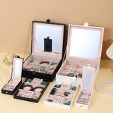 Black Luxury Quilted Jewelry Storage Box with Mirror and Multi-Layer Compartments - Top-Down View