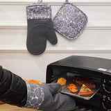 Grey 4-Piece Set Heat Resistant Silicone Kitchen Gloves Set - 4-Piece Set with Oven Mitts & Pot Holders for Safe Cooking & Baking - Close-Up Angle