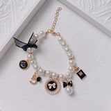 Black 4-PCS Pearl Charm Pet Necklace - Adjustable Bowknot Collar for Small Dogs & Cats (S: 20+5CM) - Top-Down View