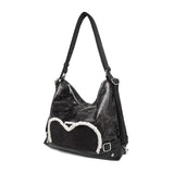 Stylish black tote backpack with heart embellishment - can be worn on one shoulder or as a backpack - Side View