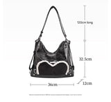 Stylish black tote backpack with heart embellishment - can be worn on one shoulder or as a backpack - Top-Down View