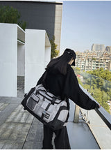 Grey Unisex Travel Bag with Utility Buckles and Wet/Dry Compartments - Top-Down View