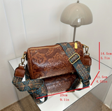 Black Vintage Embossed Crossbody Barrel Bag with Wide Adjustable Guitar Strap - Side View