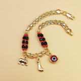 Gold-Tone Chain Bracelet with Red and Black Beads, Elephant Charm, Feather Pendant, and Round Stone Accent – 19 cm Length