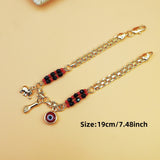 Gold-Tone Chain Bracelet with Red and Black Beads, Elephant Charm, Feather Pendant, and Round Stone Accent – 19 cm Length - Top-Down View