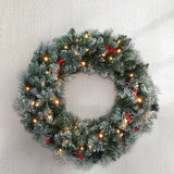 Jingle Jollys 60cm Illuminated Snow-Frosted Christmas Wreath with Red Berry Accents - Close-Up Angle